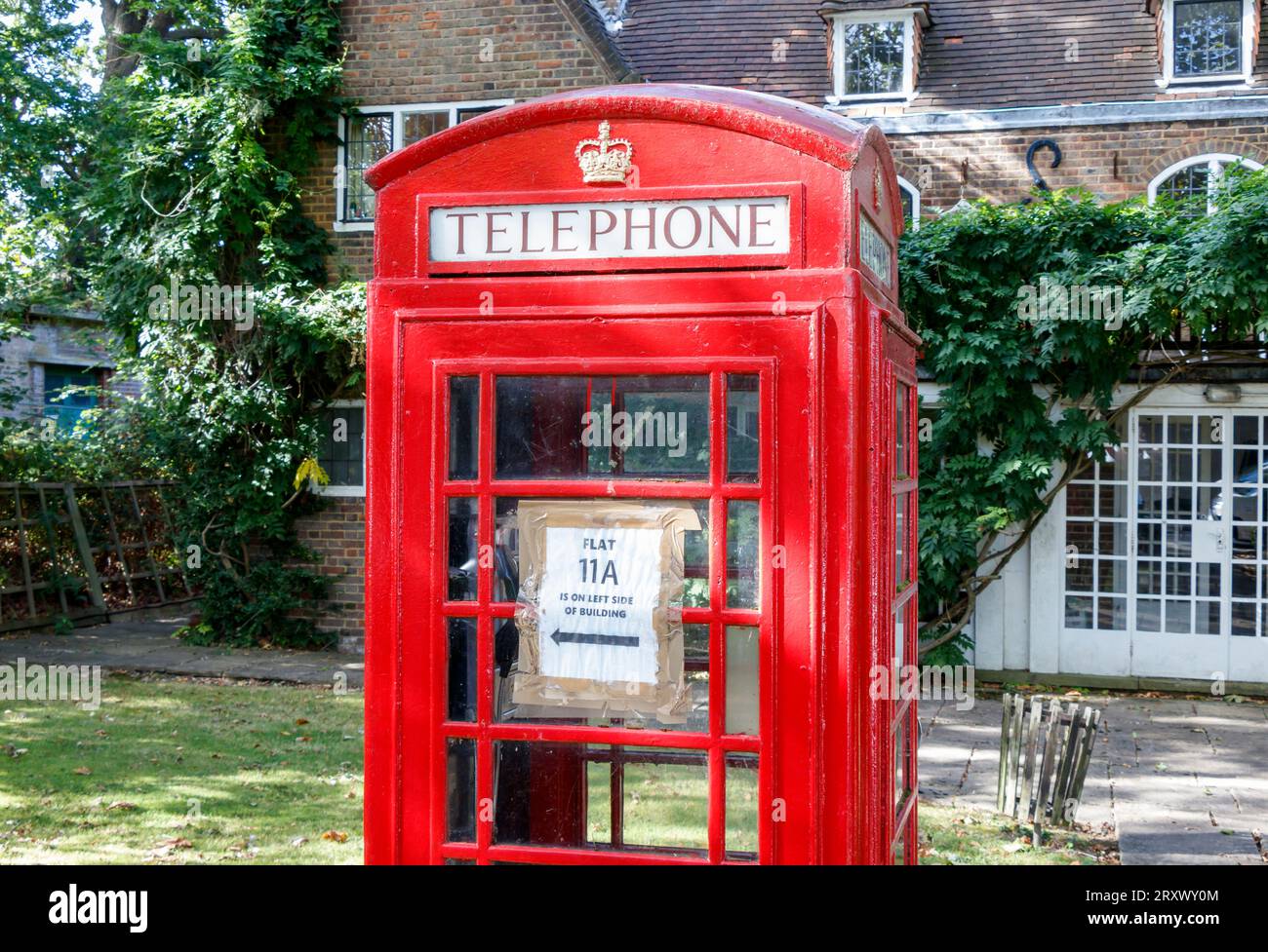 A red traditional K6 British telephone box in Hampstead Garden Suburb, London, UK Stock Photo