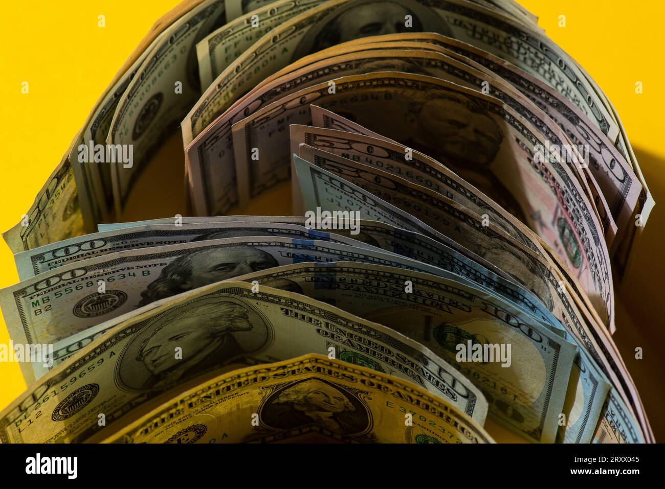 Stack of American 100 USD dollars bills On A Yellow background  Business background from Roll US dollar banknotes in a Yellow background Stock Photo