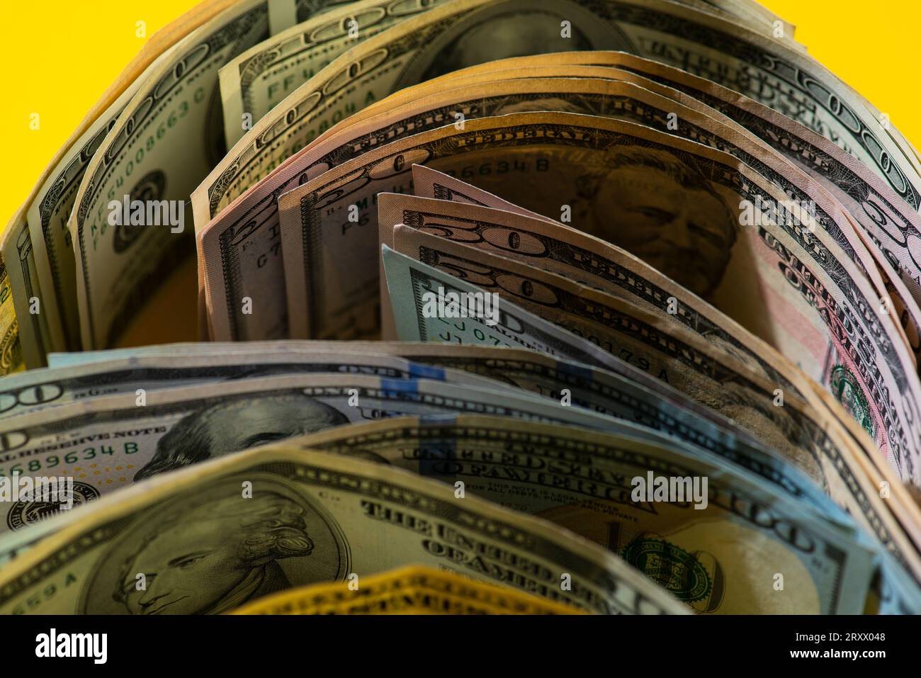Stack of American 100 USD dollars bills On A Yellow background  Business background from Roll US dollar banknotes in a Yellow background Stock Photo