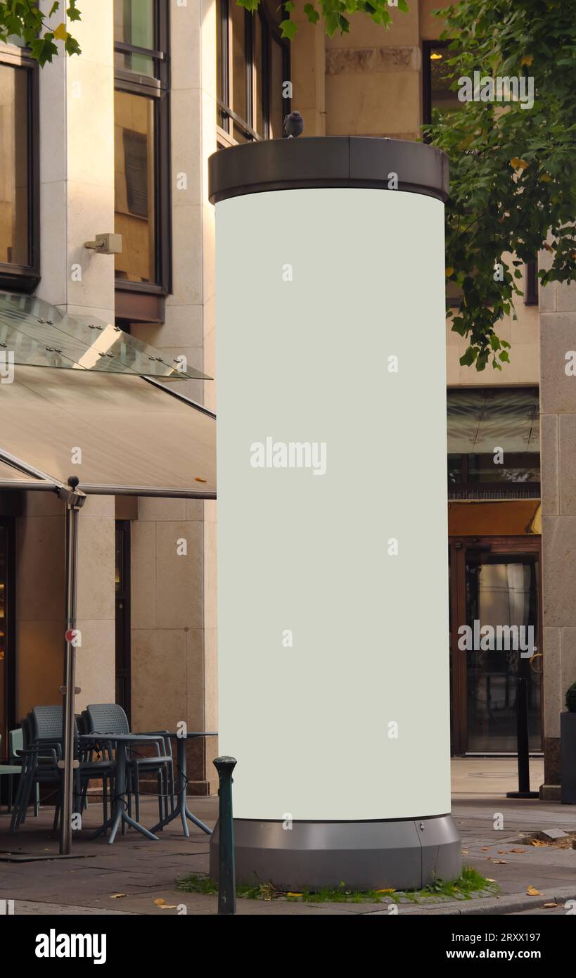 Empty advertising pillar in a city with grey free copy space, promotion ...