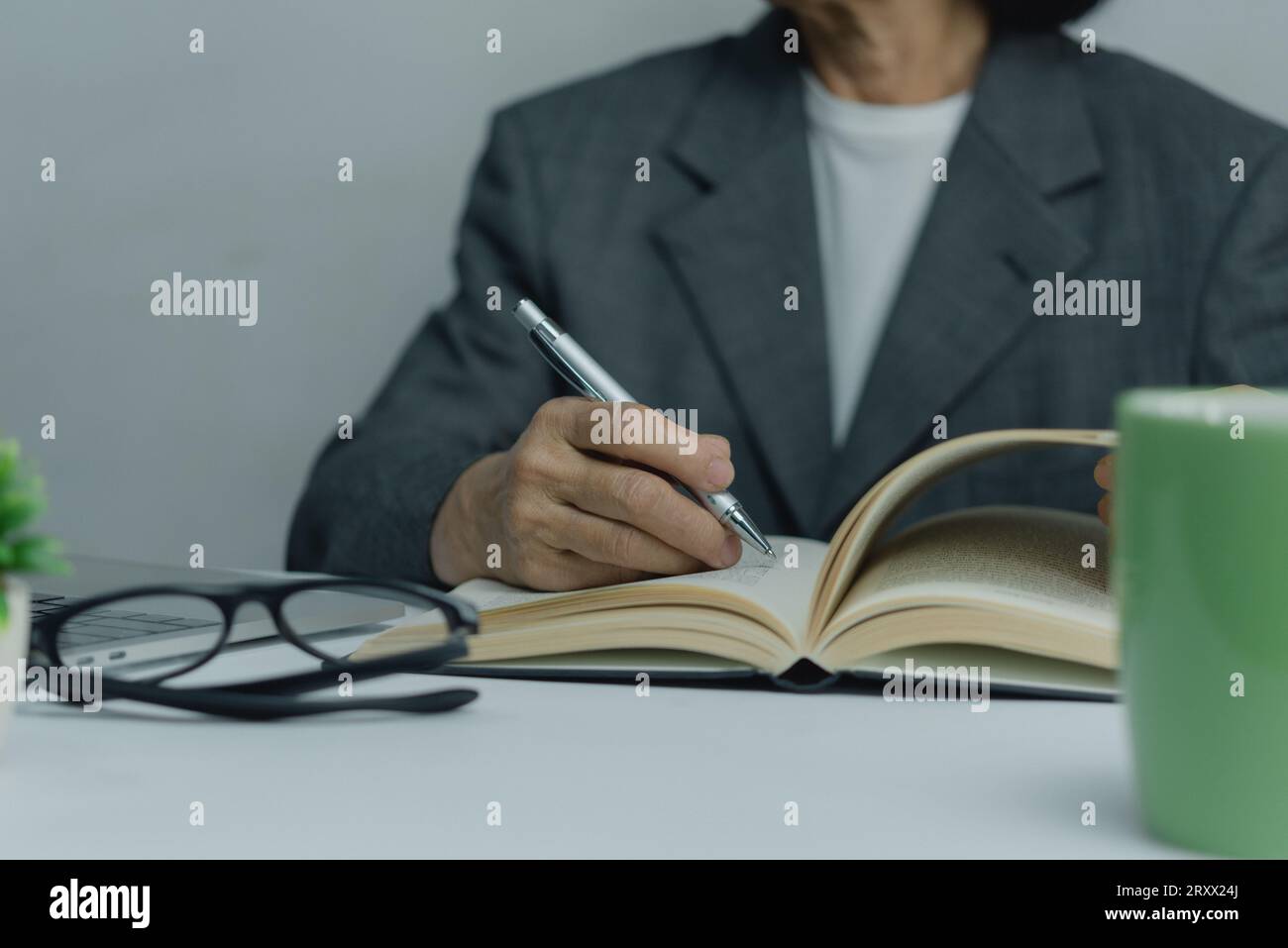 Hands Writing with Pen on Notebook. concept of work, study, and education. Stock Photo
