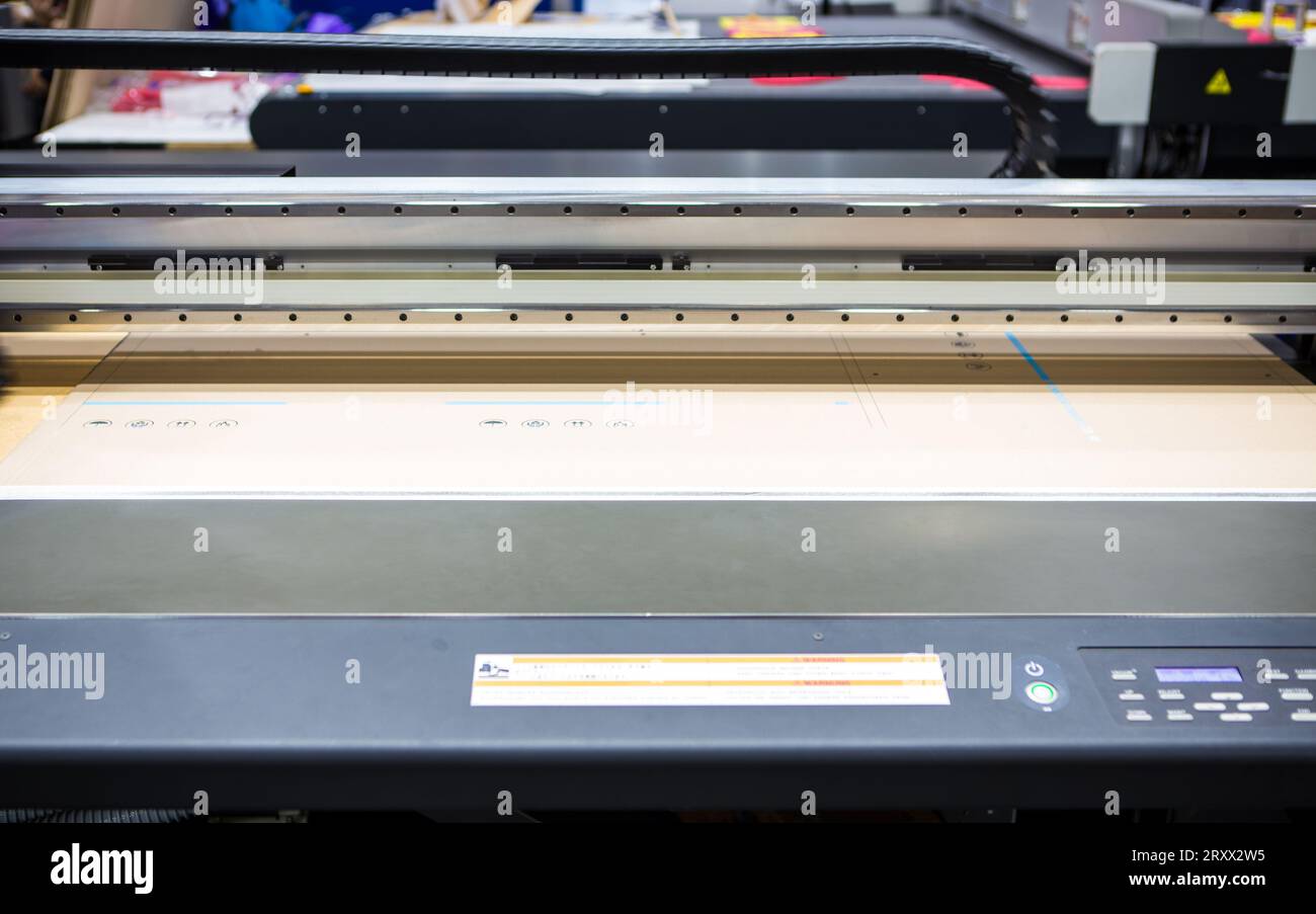 Flatbed UV LED Inkjet Printer. Cardboard packaging printing. Stock Photo