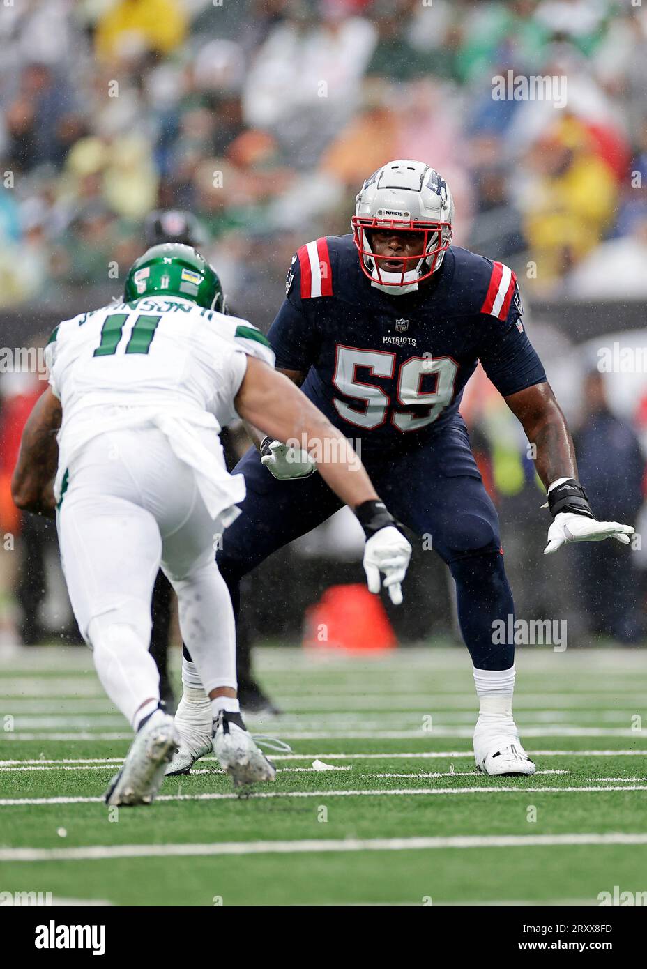 New England Patriots offensive tackle Vederian Lowe (59) defends New York  Jets linebacker Jermaine Johnson (11) during an NFL football game Sunday,  Sept. 24, 2023, in East Rutherford, N.J. (AP Photo/Adam Hunger