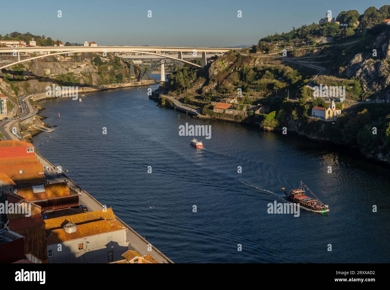 Visitors and tourists by the bridge and streets in the Douro river ...