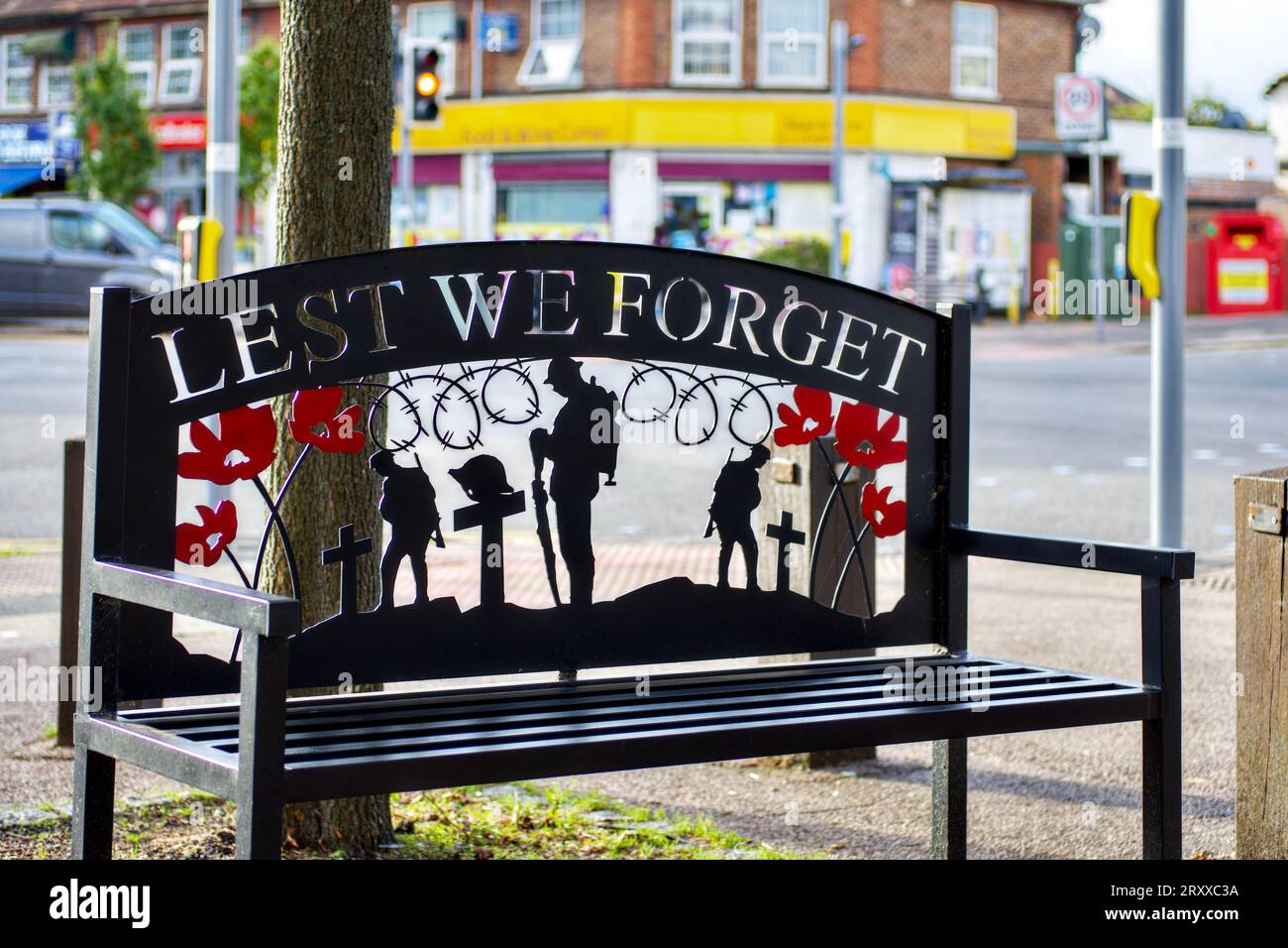 Lest We Forget public seat outside Parade of shops, Bushey Mill Lane, Watford, Hertfordshire, England, UK Stock Photo