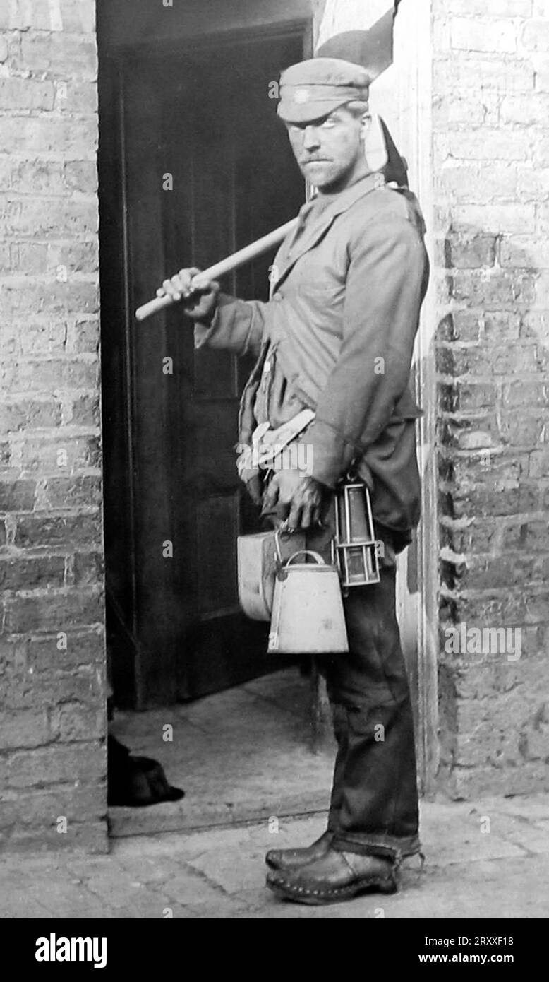 A coal miner arrives home after a shift at an English coal mine