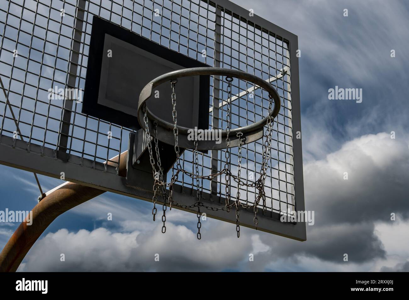 Metal Basketball Board And Ring With Chains In Front Of Sky With Heavy Clouds Stock Photo Alamy