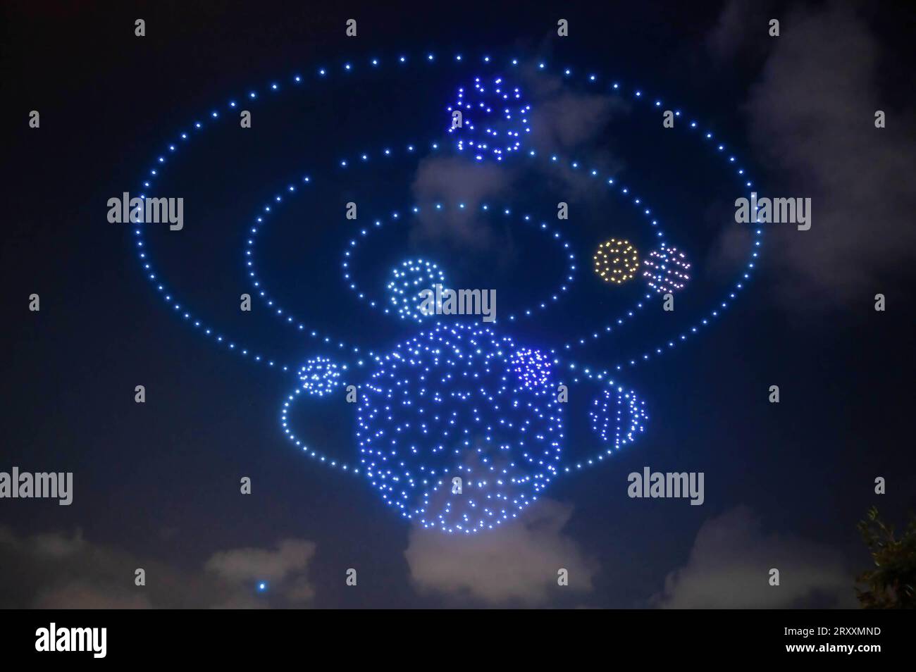 Drones light show, forming a solar system in space over Victoria Harbour in Hong Kong, with one