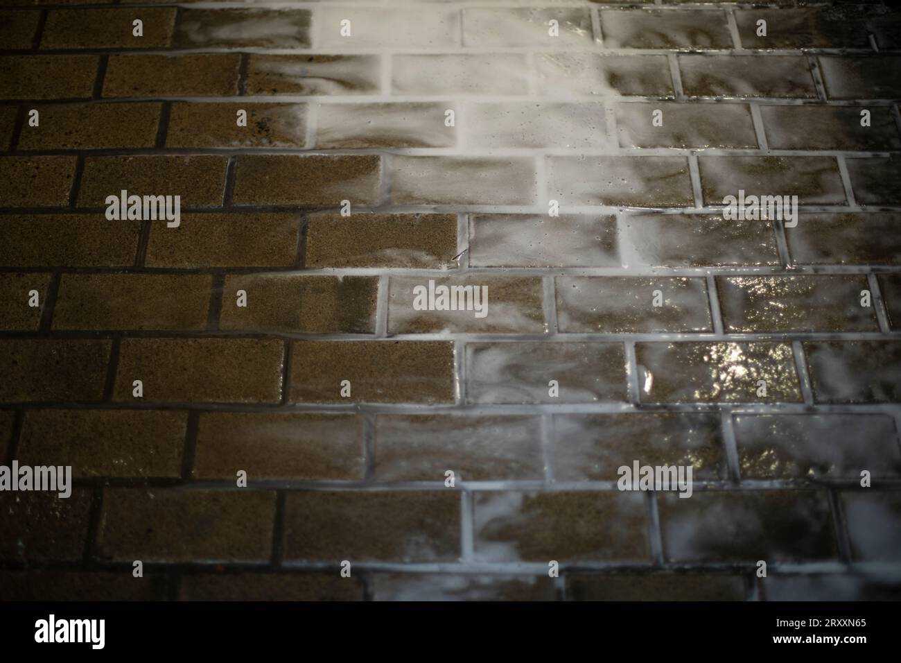 Rinsing dirt off tiles. The flow of water on the floor. Housekeeping