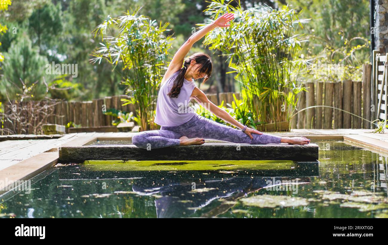 A woman doing stretching exercises outdoors Stock Photo - Alamy