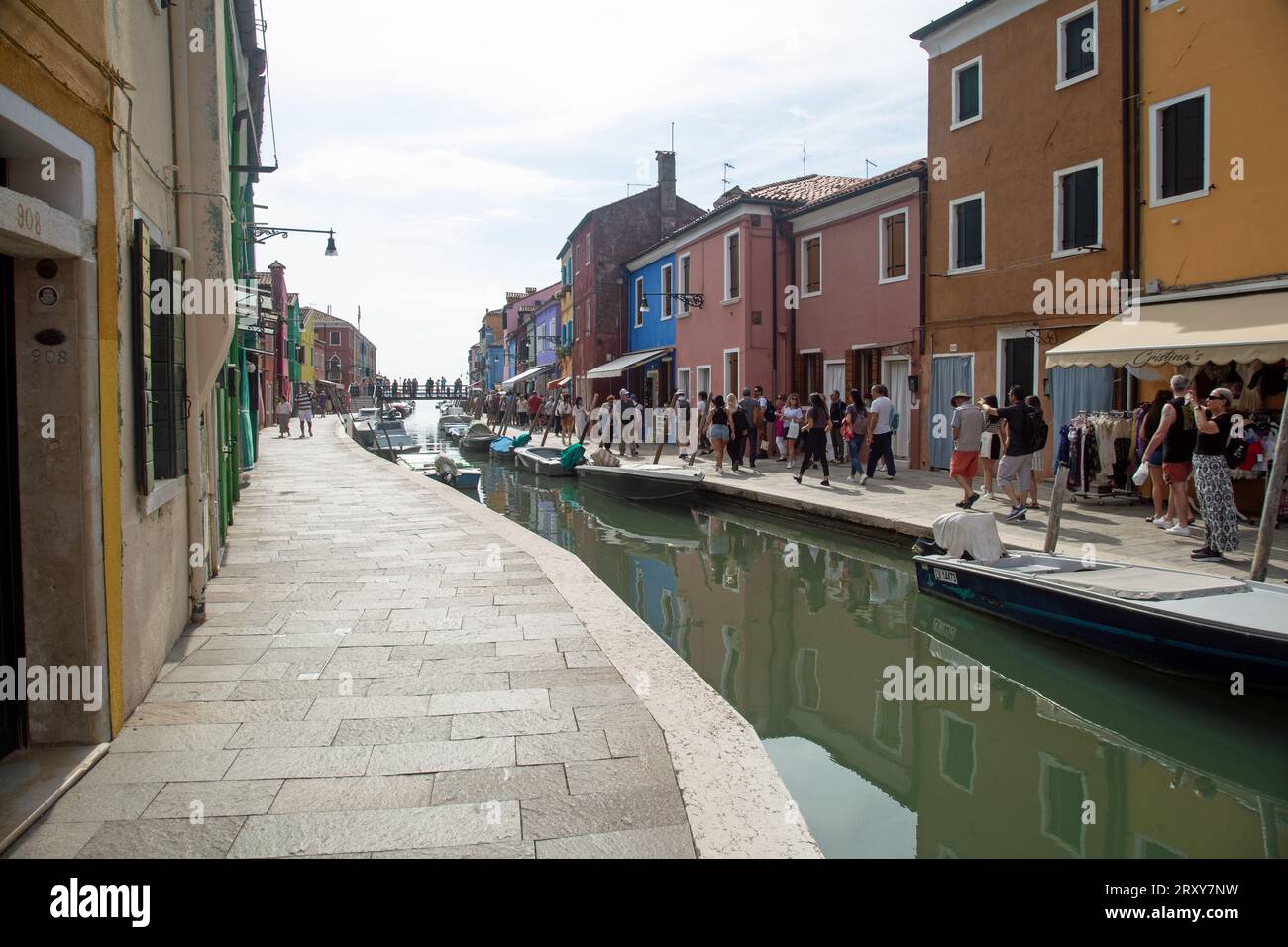 Burano, Veneto, Italy, September 2023, Street scene showing boats on the canal and colourful painted houses Stock Photo