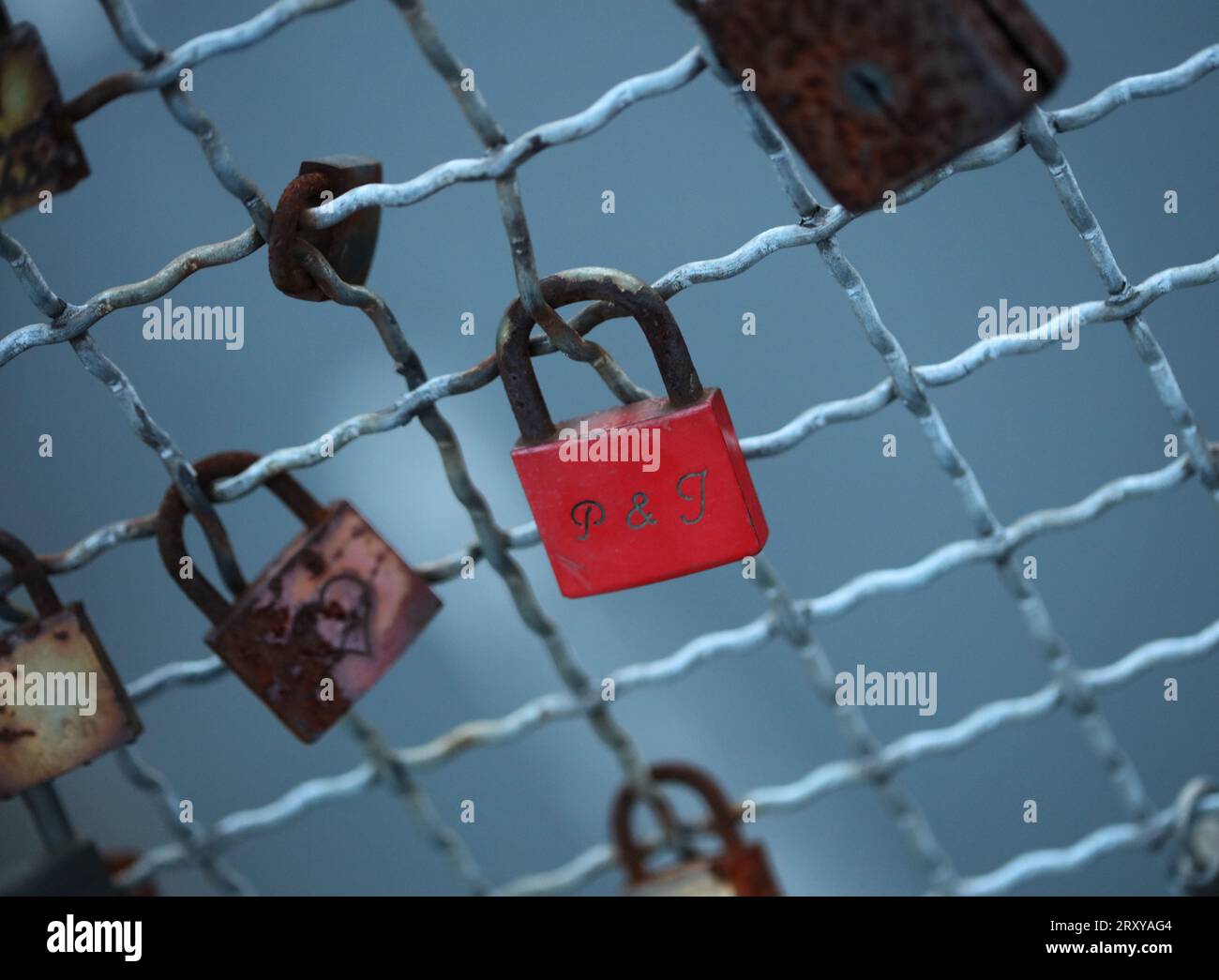 Old and new locks with names and dates written on them couples