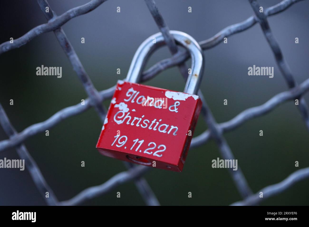 Old and new locks with names and dates written on them couples