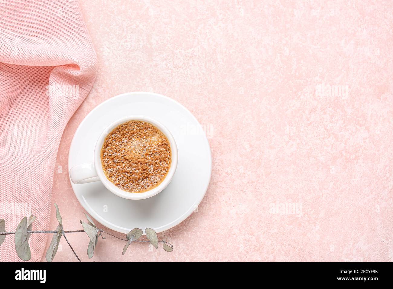 Cup of hot espresso and eucalyptus on pink background Stock Photo