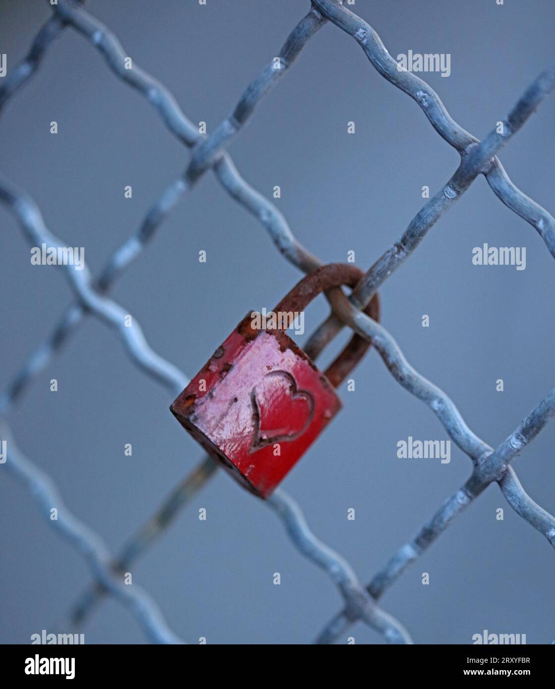 Old and new locks with names and dates written on them couples