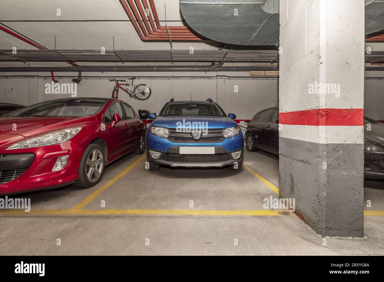 Vehicles parked in an underground parking lot of an urban residential