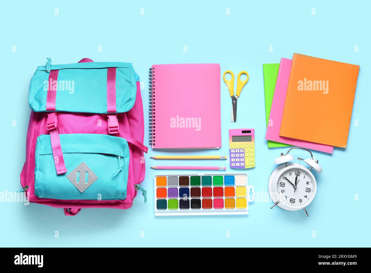 Stylish school backpack with different stationery on blue background Stock Photo