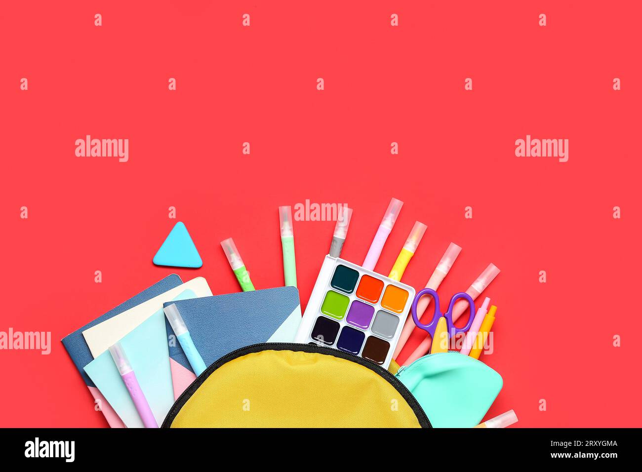 Stylish school backpack with different stationery on red background Stock Photo