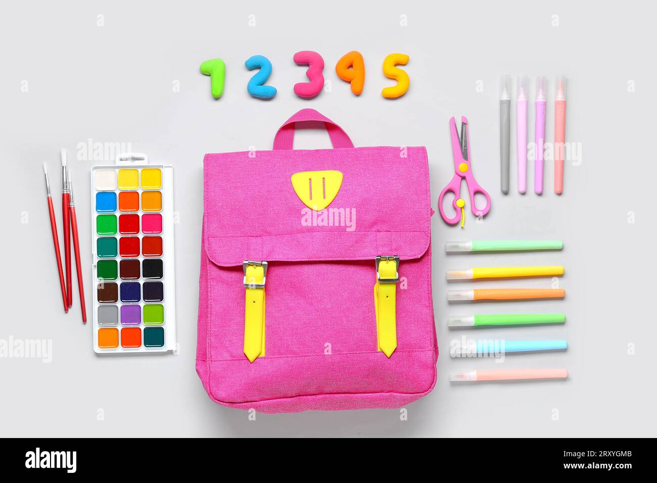 Stylish school backpack with different stationery on grey background Stock Photo