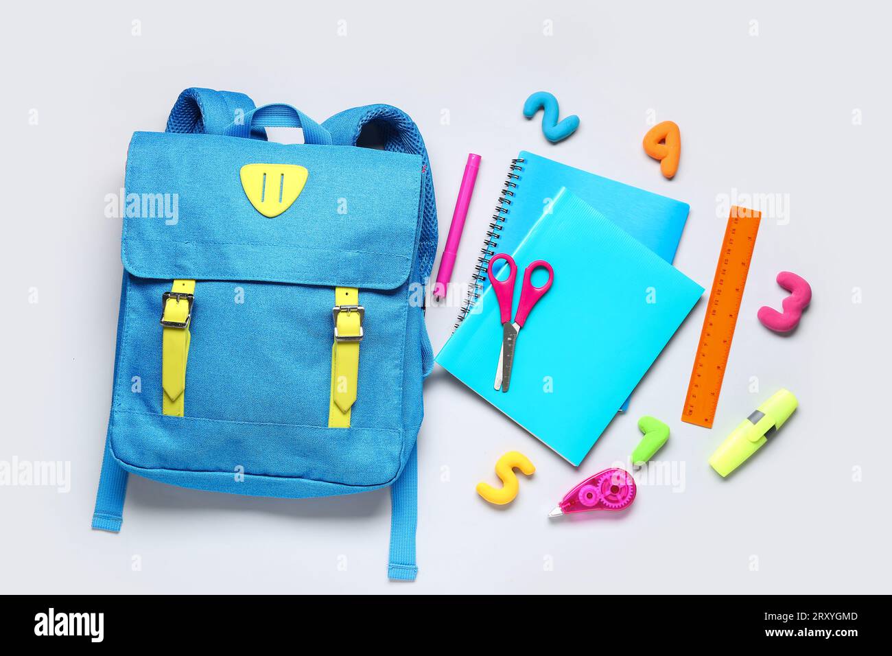 Stylish school backpack with different stationery on grey background Stock Photo