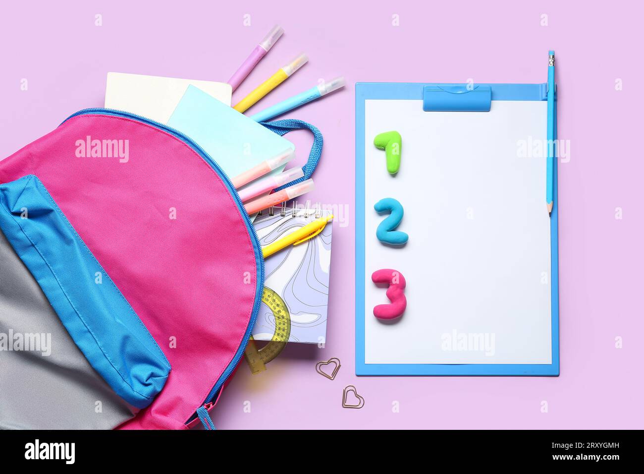 Stylish school backpack with different stationery on color background Stock Photo