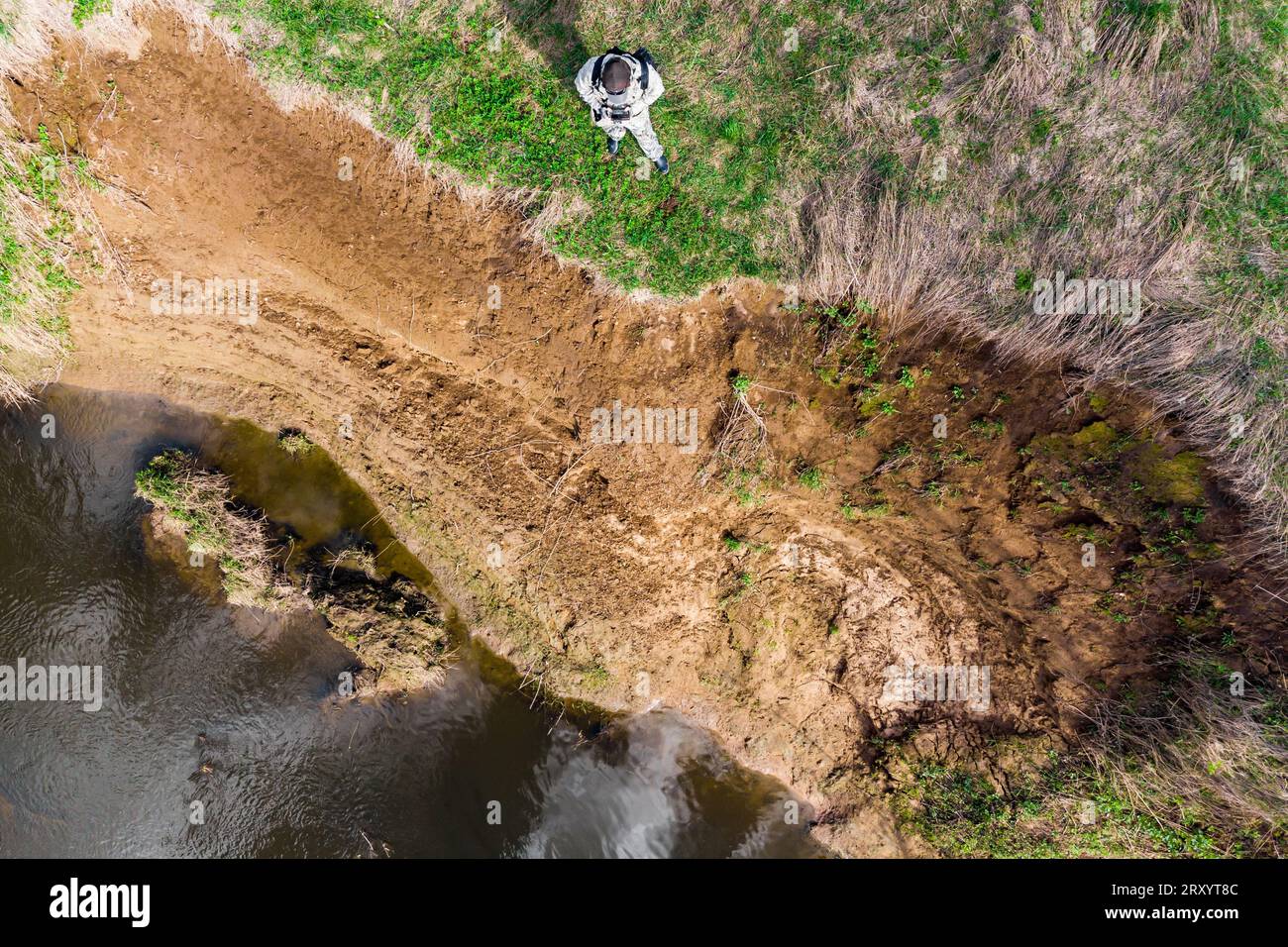 Shooting from a drone over a cliff on the river. Landslide processes on ...