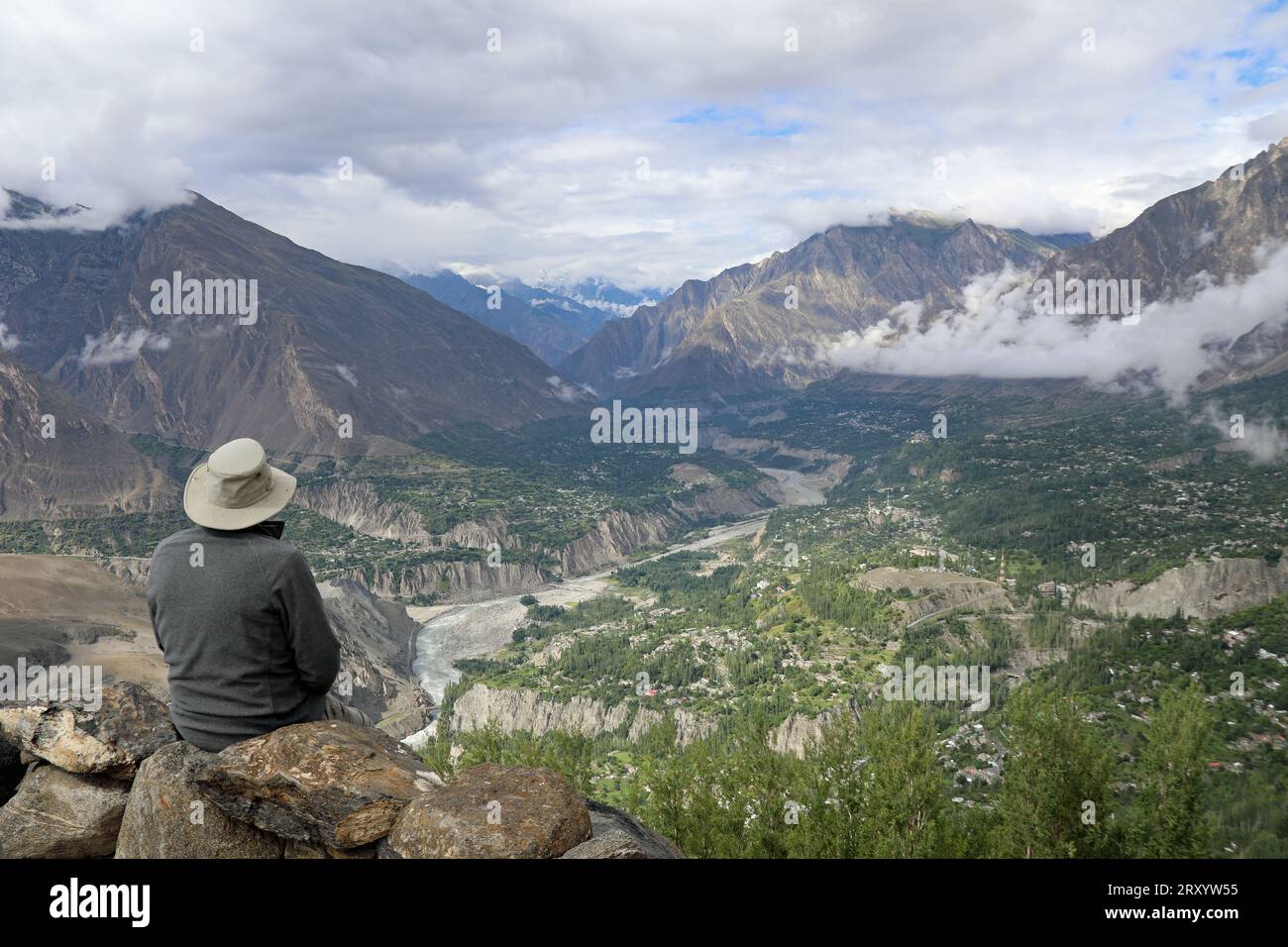 Tourist gazing over the Hunza Valley from a high viewpoint Stock Photo