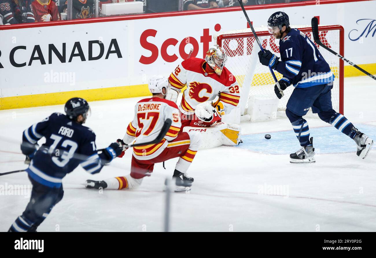 Winnipeg Jets' Parker Ford (73) scores on Calgary Flames goaltender