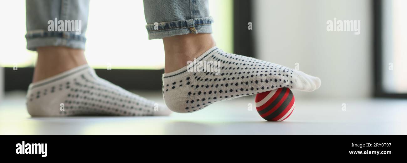 Woman does foot massage with ball to eliminate tension Stock Photo Alamy