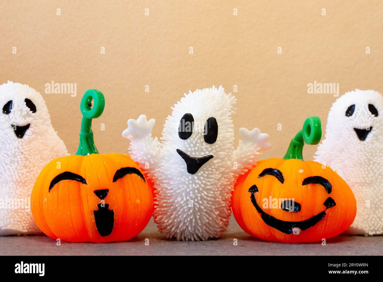 Pumpkins and ghosts celebrating trick or treat on Halloween day. Smiling orange Jack-O'-Lantern. Stock Photo