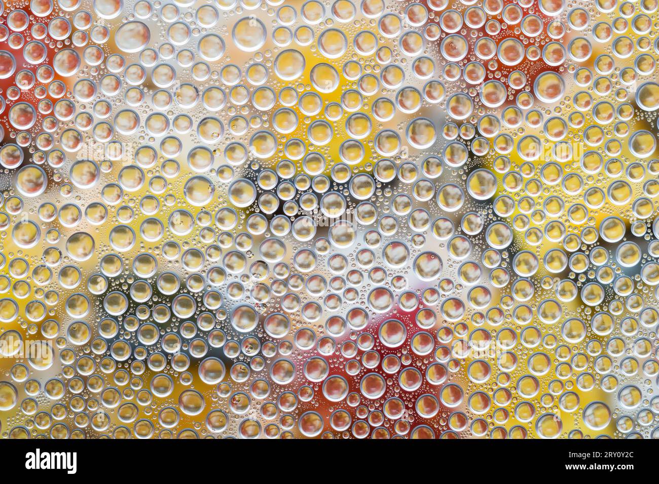 Water drops on glass surface with colorful background Stock Photo - Alamy