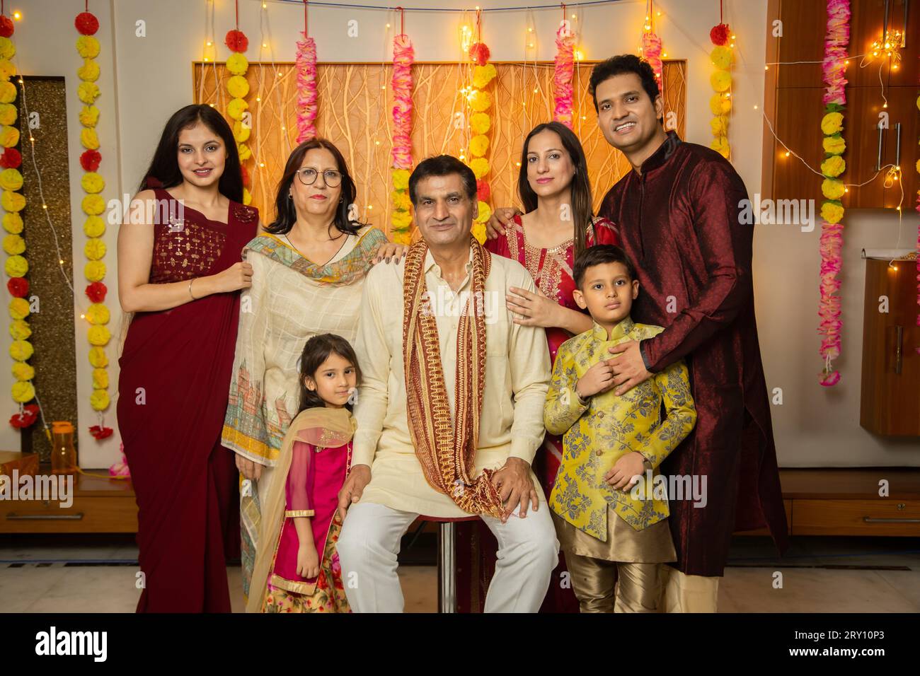 Portrait of happy Indian family in traditional dress celebrating diwali festival at home. Stock Photo