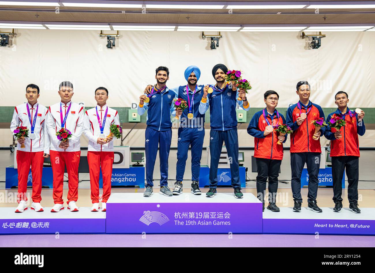 (230928) -- HANGZHOU, Sept. 28, 2023 (Xinhua) -- Silver medalists team China, gold medalists team India and bronze medalists team Vietnam (L-R) attend the awarding ceremony for the Men's Team 10m Air Rifle of Shooting at the 19th Asian Games in Hangzhou, east China's Zhejiang Province, Sept. 28, 2023. (Xinhua/Sun Fei) Stock Photo