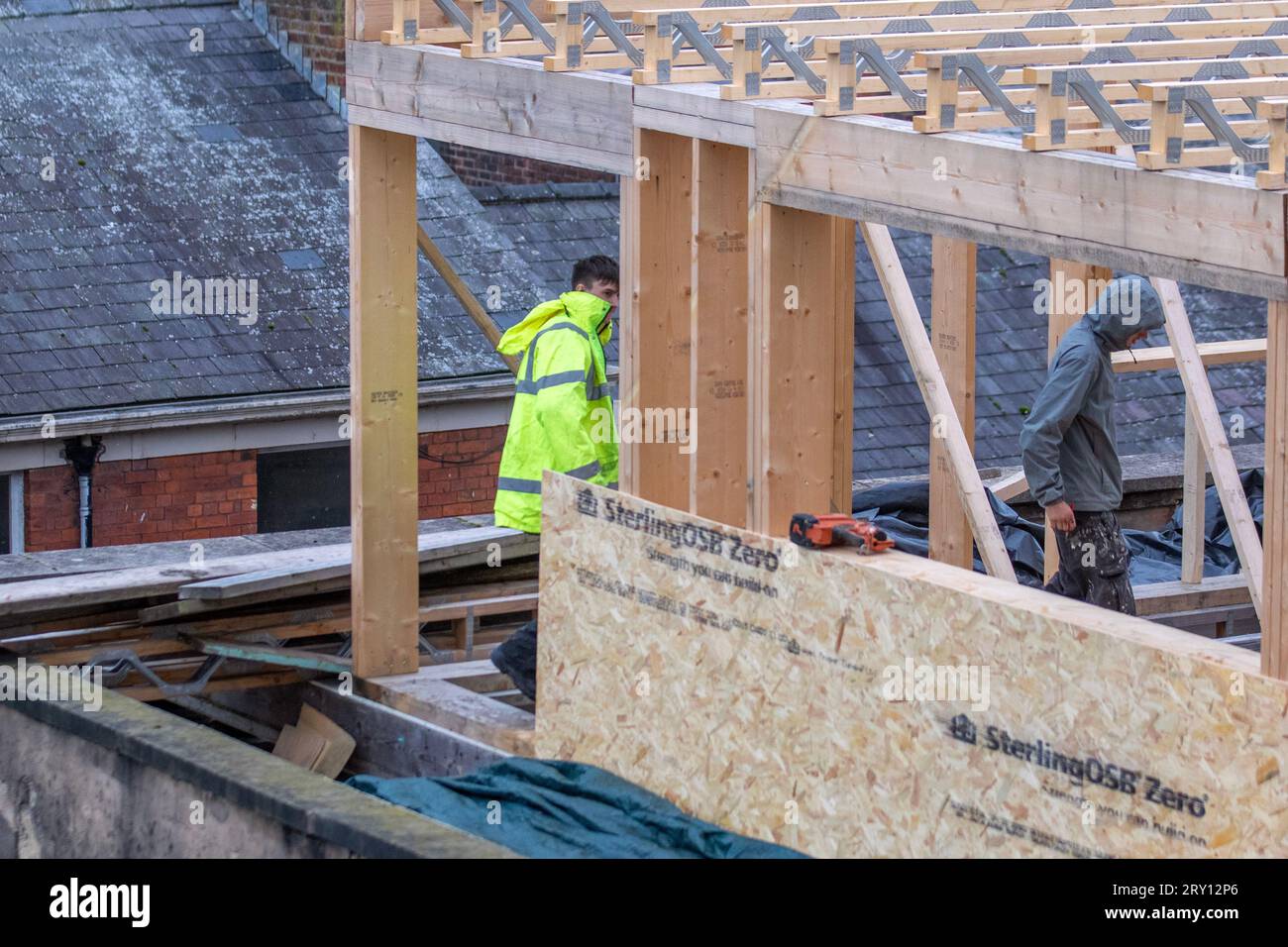Extraordinary timber roof extension underway on city centre building in Preston. The elevation uses waterproof SterlingOSB Zero timbers and lattice roof trusses to support an extension. Stock Photo
