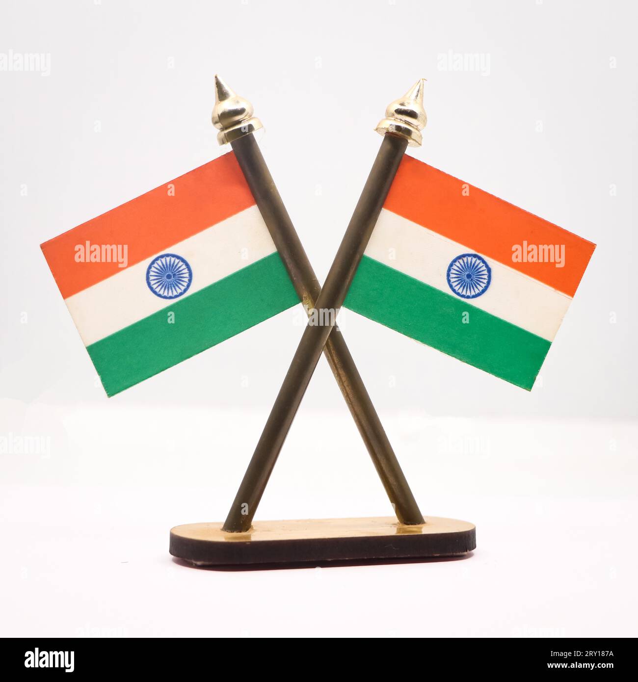 The national flag of India in republic tricolors with the ashoka chakra fixed on two poles isolated in a white background Stock Photo