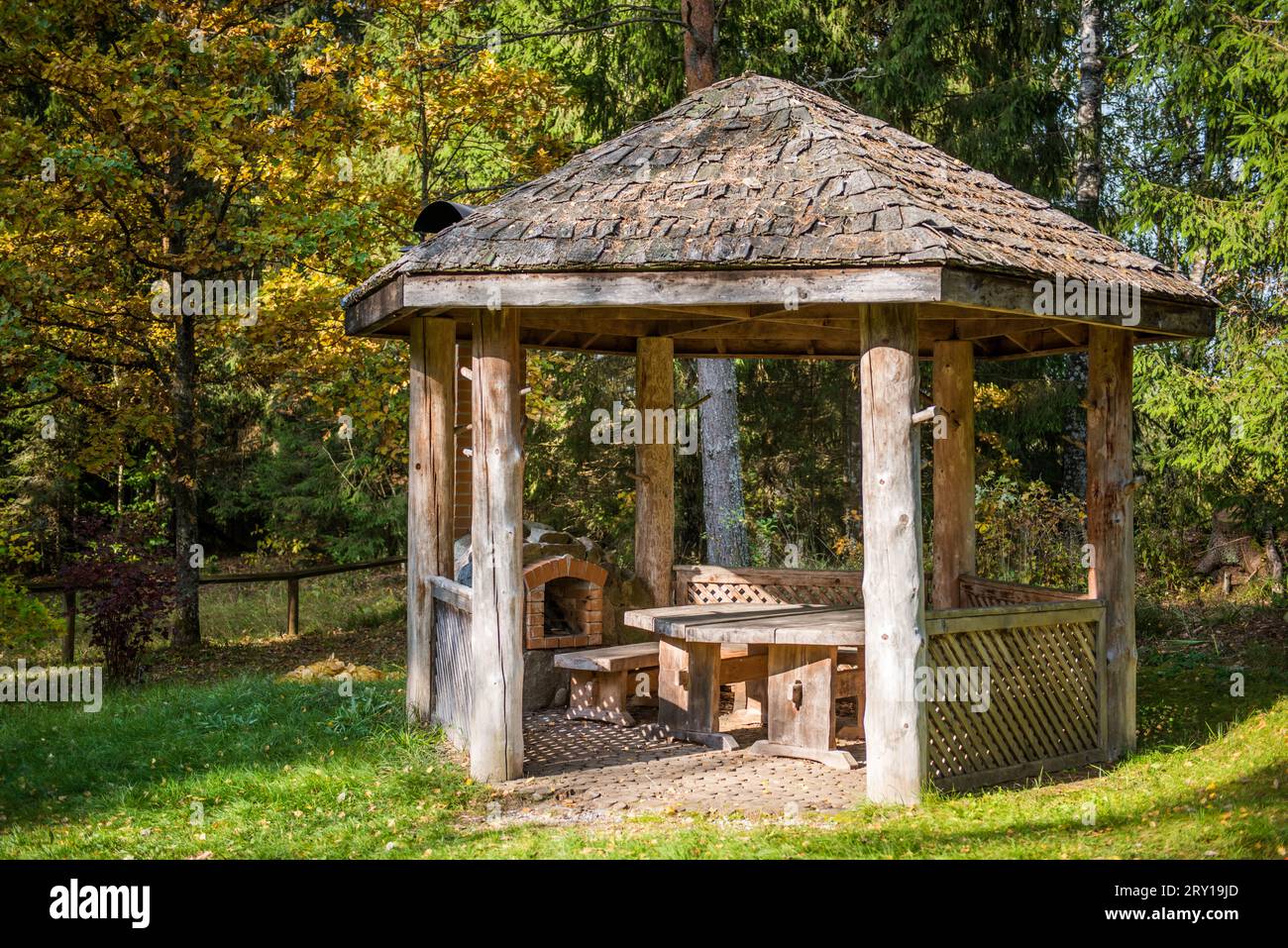 Wooden gazebo and brick stove for cooking food outdoors. Public park