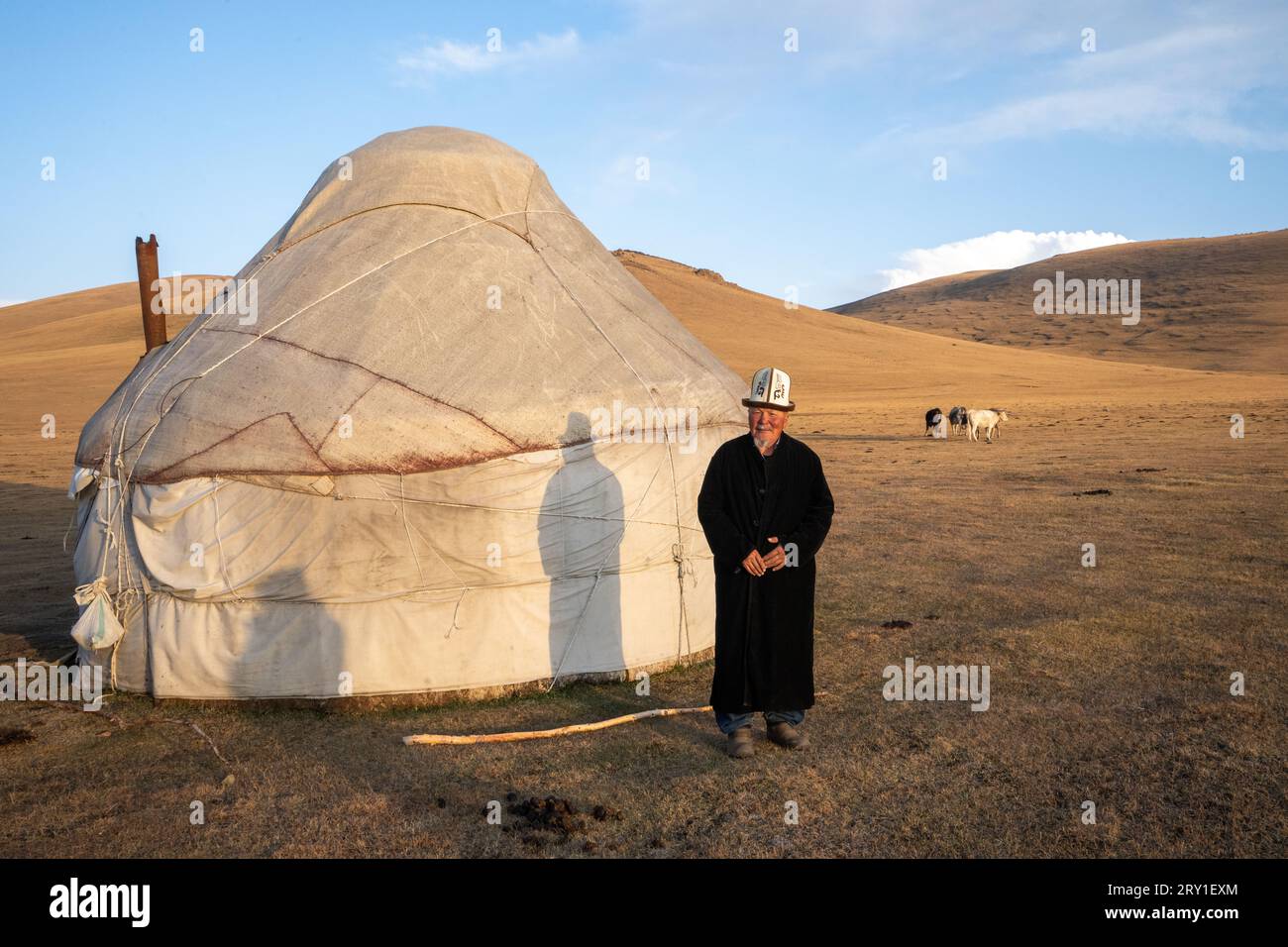 Kyrgyz man in traditional dress near his yurt kyrgyzstan Stock Photo