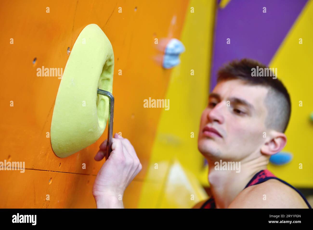 Climber will gathers an artificial wall for rock-climbing. Extreme and healthy lifestyle concept. Stock Photo