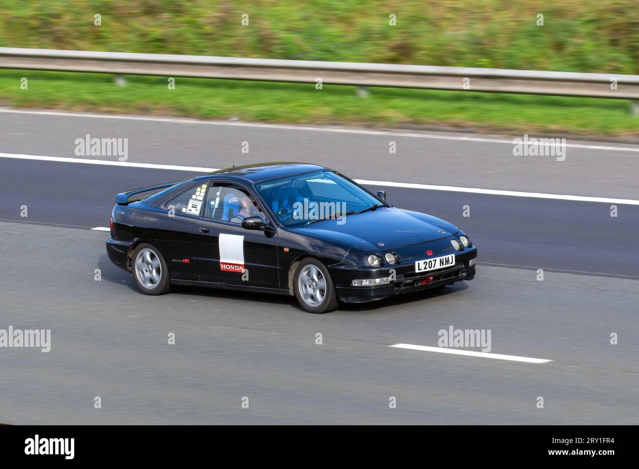 1993 90s nineties Honda, Japanese sports coupe with VTEC powerplant; travelling at speed on the M6 motorway in Greater Manchester, UK Stock Photo