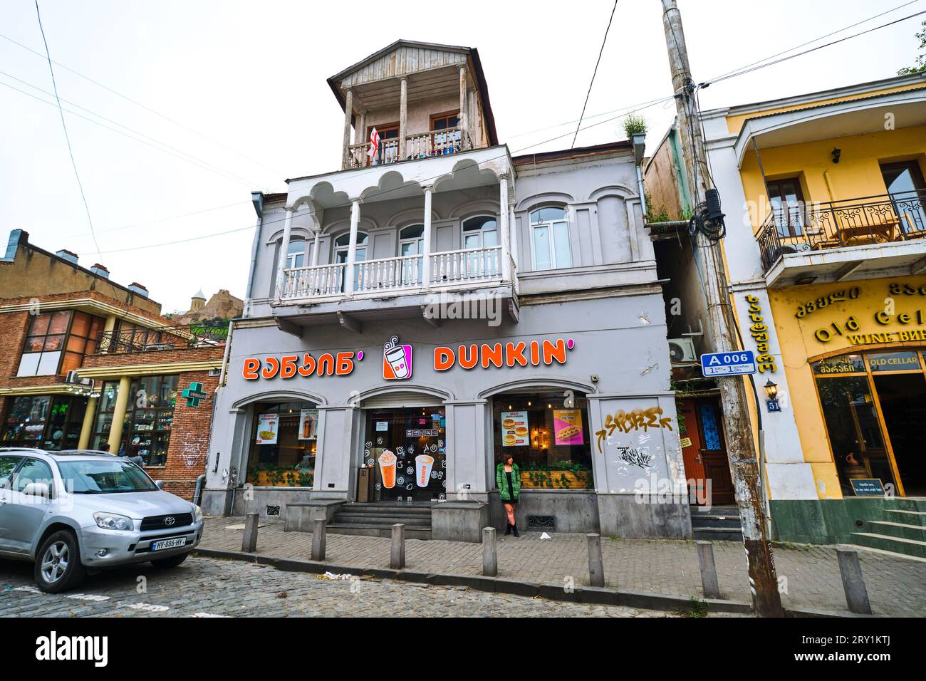 The sign for Dunkin' Donuts, the American fast food franchise. The sign is in both English and Georgian languages. In Tbilisi, Georgia, Europe. Stock Photo