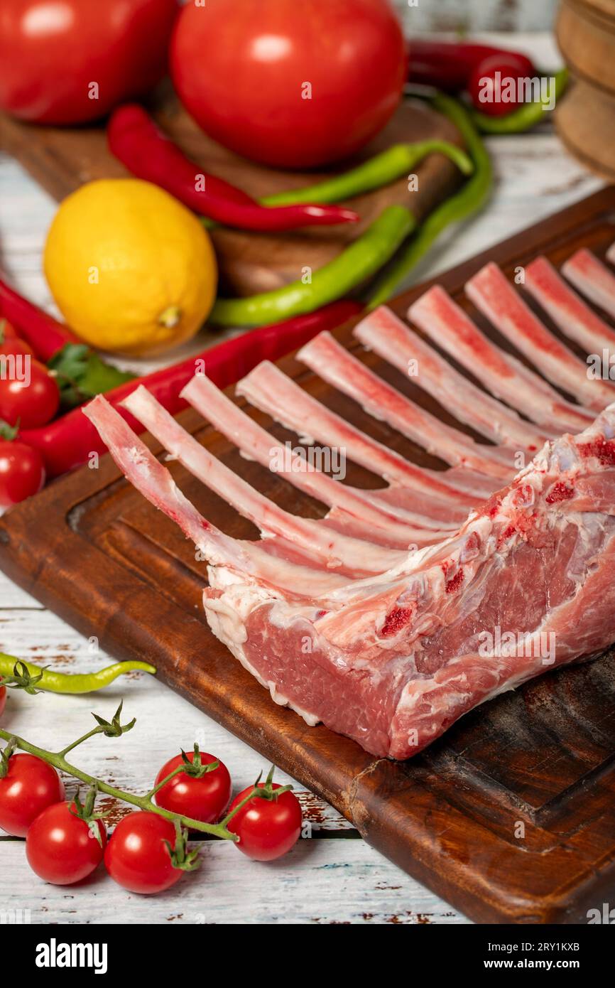 Lamb rack cutlet on wood background. Raw lamb chops with herbs and spices Stock Photo Alamy
