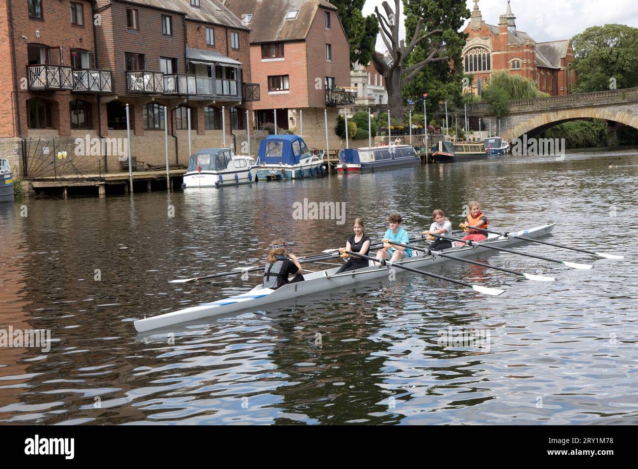 Young rowers in 4 seater skiff near Workman Bridge Evesham Worcestershire UK Stock Photo