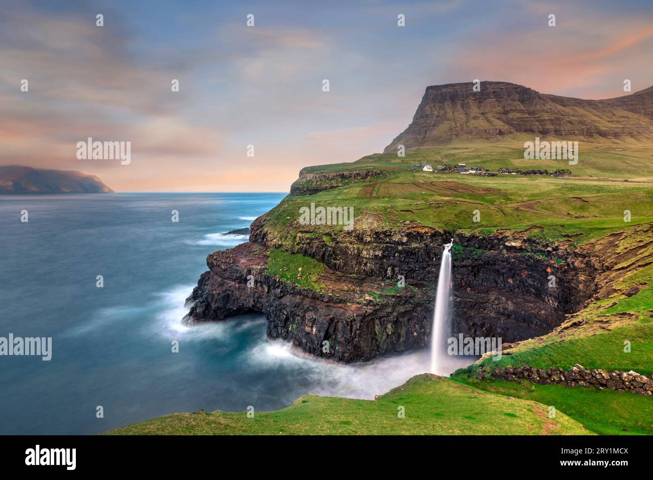 Spectacular Mulafossur waterfall on the island Vagar in the Faroe Islands Stock Photo