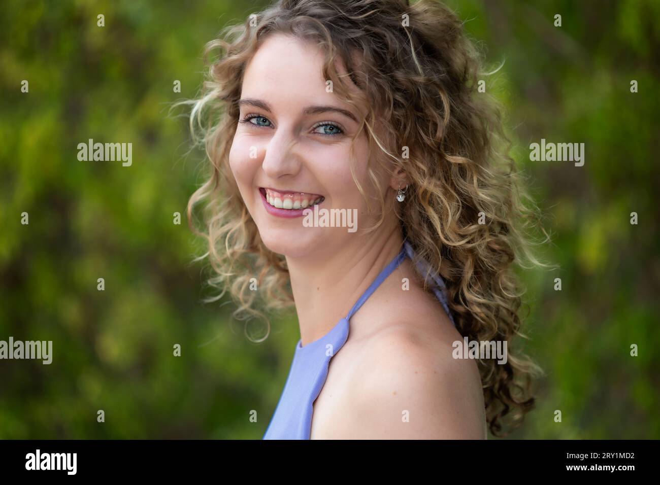 Head and shoulders portrait of a smiling, young Caucasian woman with ...