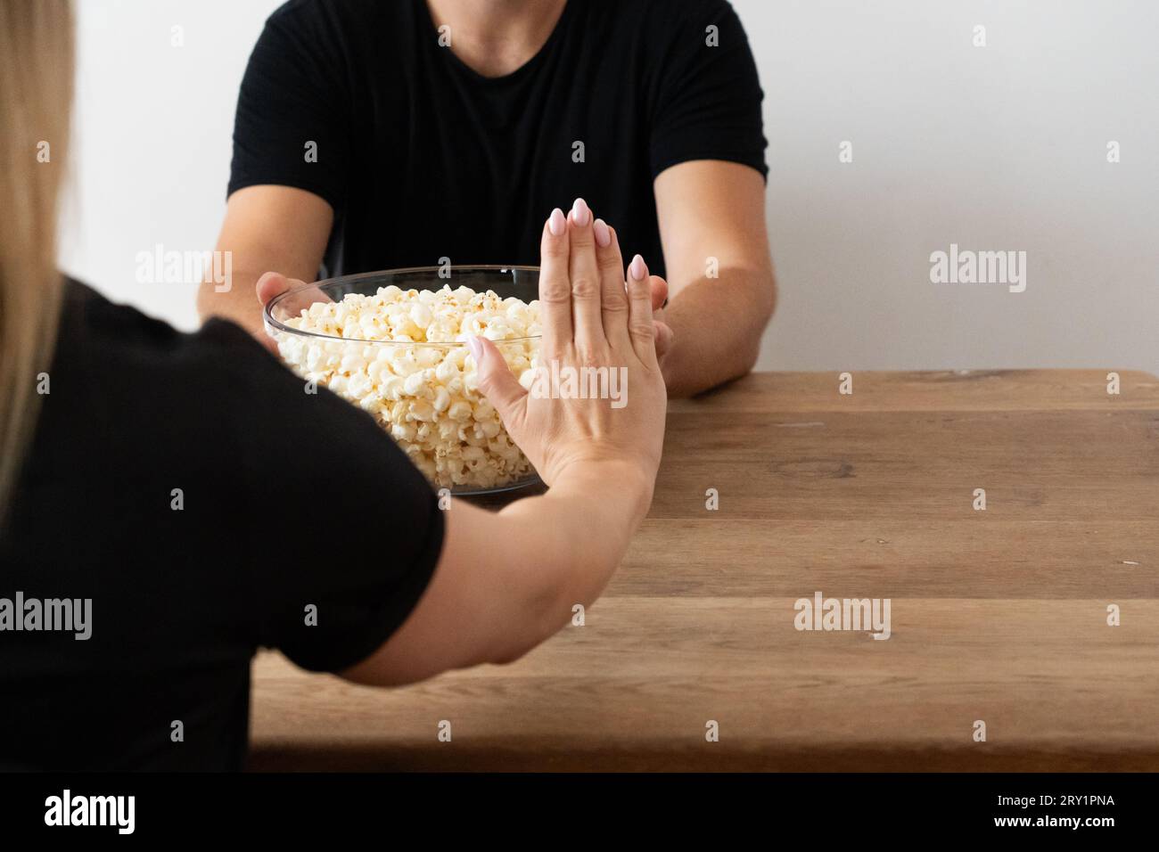 Woman Declining Popcorn: Avoiding Unhealthy Fatty, Salty Snacks, Snack Avoidance, Ketogenic Diet, Carnivore Diet, Low-Carb Diet, Non-Consumption of Co Stock Photo