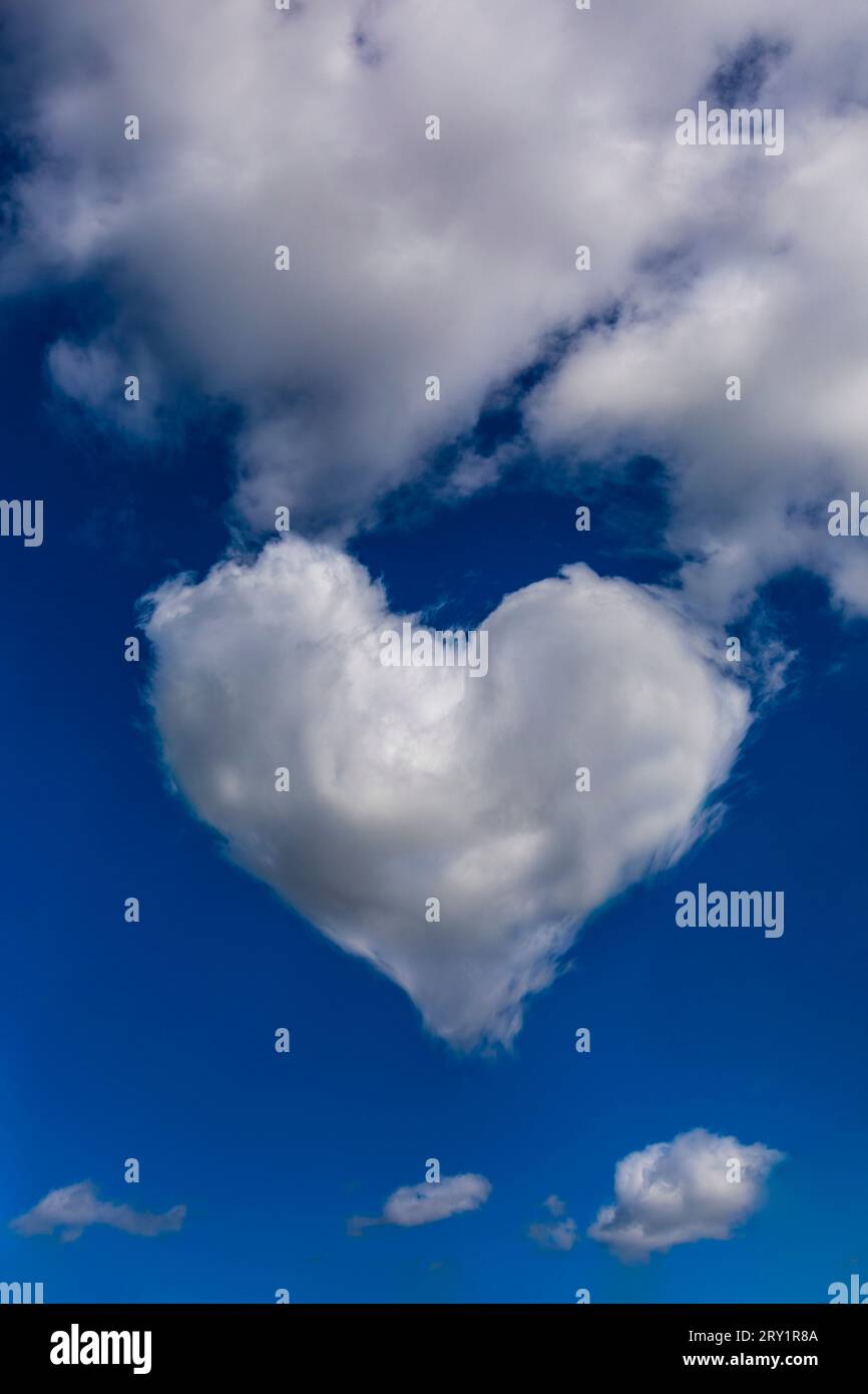 Heart shaped cloud in a blue sky. Modified image Stock Photo - Alamy
