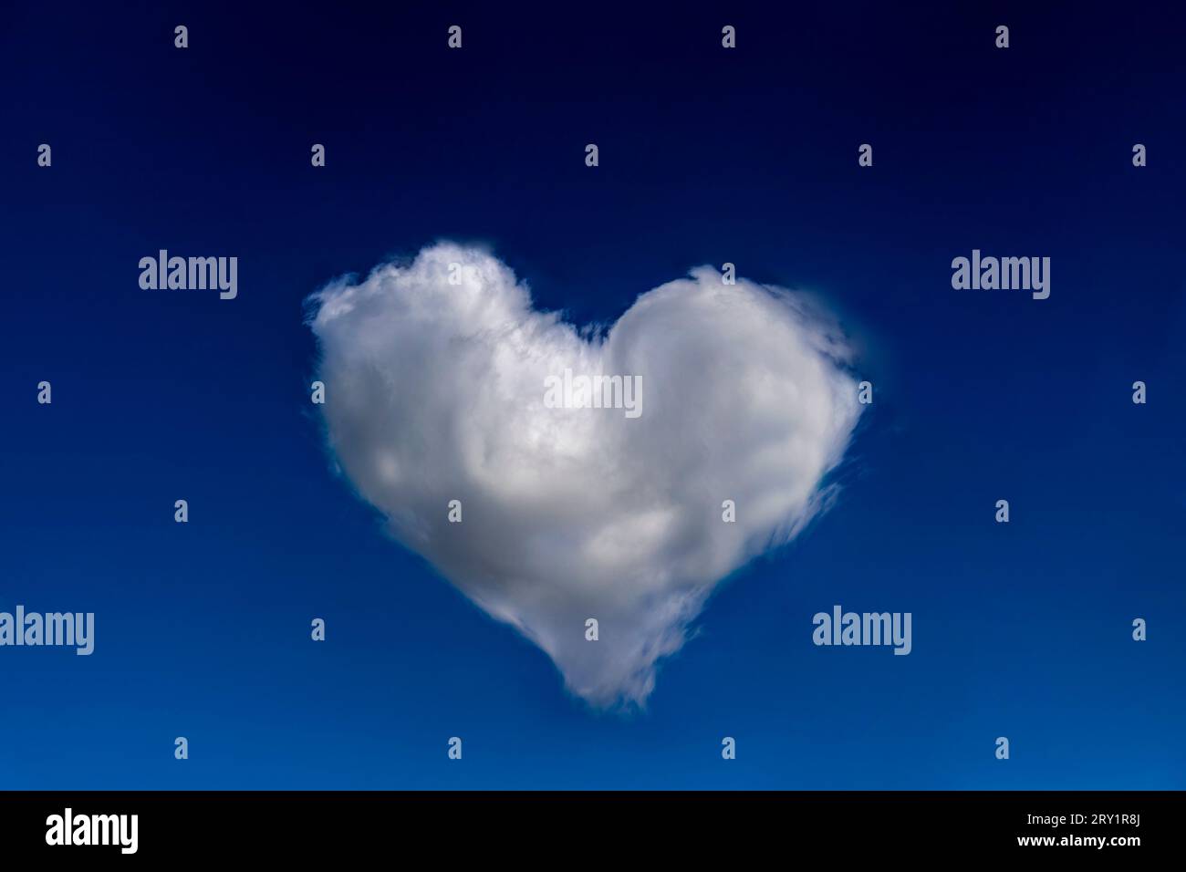 Heart shaped cloud in a blue sky. Modified image Stock Photo - Alamy