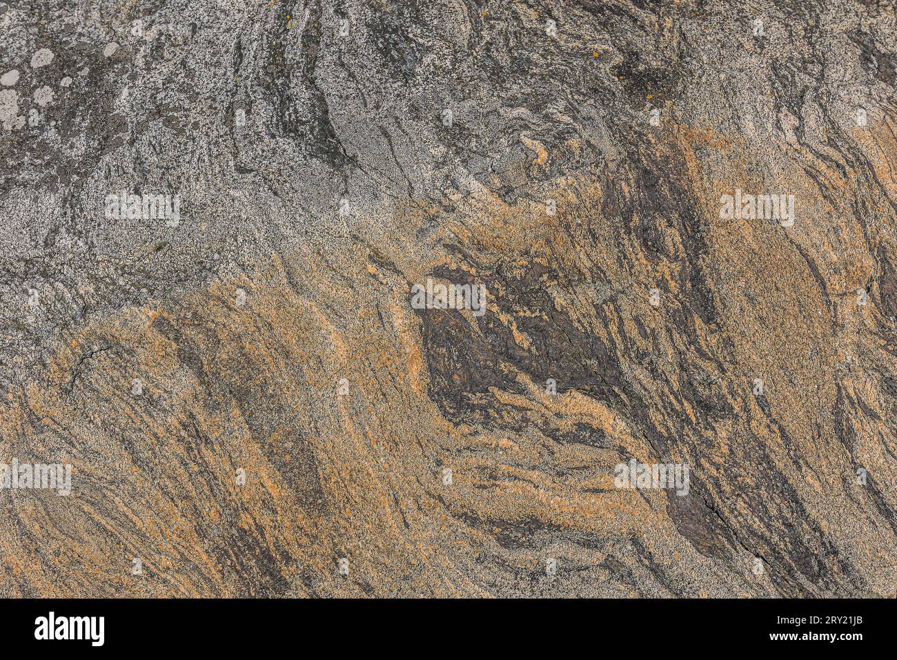 Background pattern of brown-colored granite in oblique unstructured wavy lines. Natural stone with gray and brown gradient. Dark spots in the stone Stock Photo