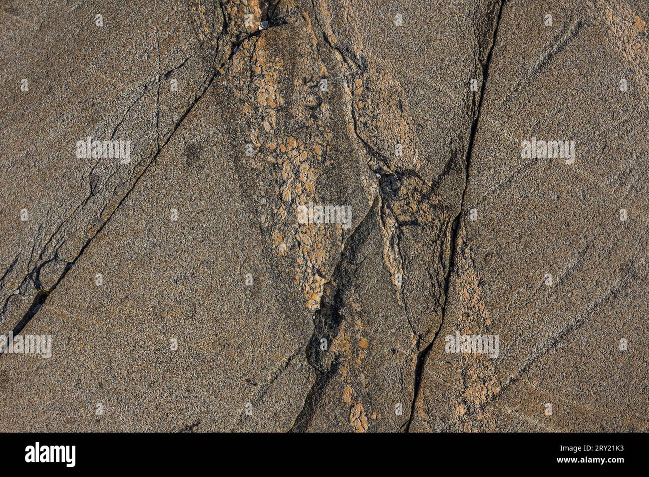 Background pattern of granite with lines running in unstructured discontinuities. Natural stone with a brown gradient. pale yellow orange spots Stock Photo