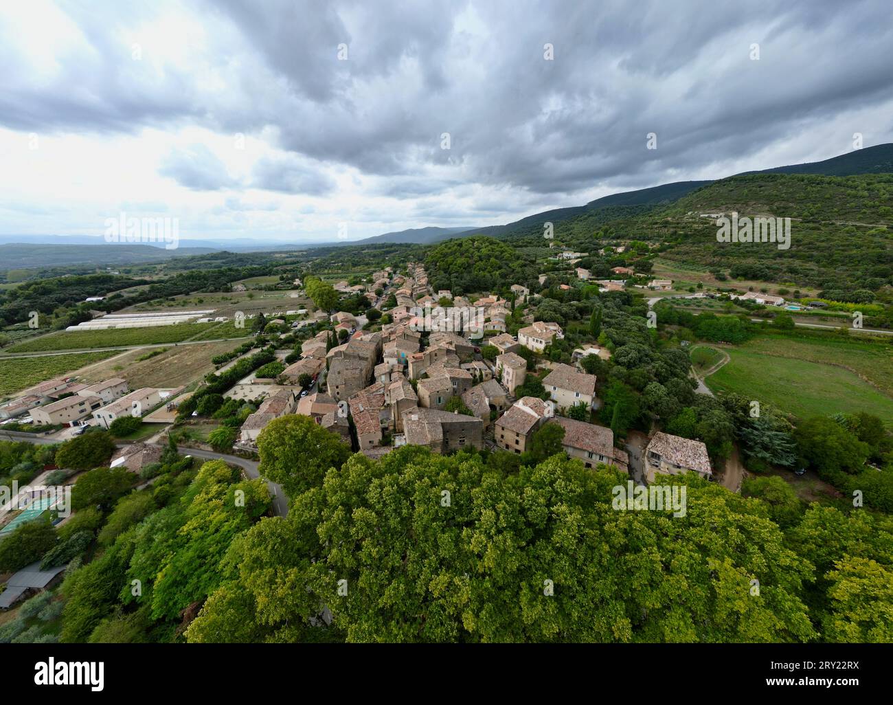 Aerial Journey Over Rustic Vaugines: A Charming Provencal Village in Vaucluse, PACA – Drone Exploration of Town Stock Photo